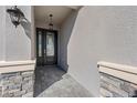 Inviting entryway with stone accents and a stylish double door entry, creating a grand entrance at 32707 Tamarind Grove Ln, Wesley Chapel, FL 33543