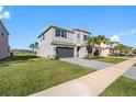 Charming home with a well-maintained lawn, paver driveway, and attractive landscaping at 32707 Tamarind Grove Ln, Wesley Chapel, FL 33543
