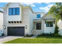 Charming two-story house featuring a brick facade, black framed windows, and well-maintained landscaping at 5024 W Dickens Ave, Tampa, FL 33629
