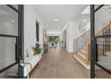 Grand foyer with light wood floors, white walls, a staircase, and a view into the living spaces at 5024 W Dickens Ave, Tampa, FL 33629