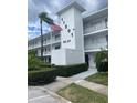 Two-story condo building with manicured landscaping and assigned parking at 11201 80Th Ave # 201, Seminole, FL 33772