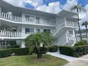 Condo building showcasing multiple units with balconies and lush greenery at 11201 80Th Ave # 201, Seminole, FL 33772