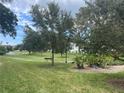Landscaped grounds with a pond, walking paths, and lush vegetation at 11201 80Th Ave # 201, Seminole, FL 33772