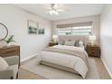 Comfortable bedroom with neutral tones, plush bedding, and ample natural light from the window at 11200 102Nd Ave # 33, Seminole, FL 33778