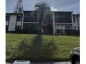 Condo building with stairs and landscaping at 2688 Pine Ridge N Way # D1, Palm Harbor, FL 34684