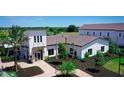 Modern clubhouse with welcoming entryway and landscaping at 18311 Wheathouse Pl, Lakewood Ranch, FL 34211