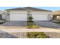 Two-story home with gray stone accents and a two-car garage at 11269 Boundless Ter, Venice, FL 34293