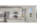 Modern kitchen with white cabinets, stainless steel appliances, and an island at 11269 Boundless Ter, Venice, FL 34293