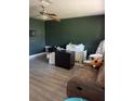 Living room with dark green walls, laminate flooring, and furniture at 5122 Lillilea Ln, New Port Richey, FL 34653
