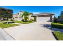 House exterior showcasing a driveway and neighborhood setting at 417 Serenity Mill Loop, Ruskin, FL 33570