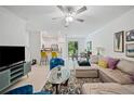 Open concept living area with comfy seating and views to the kitchen at 17399 Nectar Flume Dr, Land O Lakes, FL 34638