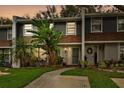 Townhome at dusk with nicely landscaped yard at 1213 Abbey Crescent Ln, Clearwater, FL 33759