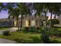 Beautiful home with a well-manicured lawn and palm trees at 9878 Sago Point Dr, Seminole, FL 33777