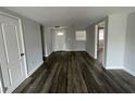 Open living area with gray walls and wood-look floors at 1024 Jadewood Ave, Clearwater, FL 33759