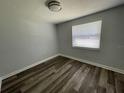 Bright bedroom with gray walls and wood-look floors at 1024 Jadewood Ave, Clearwater, FL 33759