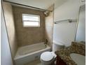 Updated bathroom with tile shower and granite countertop at 1024 Jadewood Ave, Clearwater, FL 33759