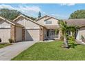 Two-story townhome with attached garage and well-maintained landscaping at 6435 Thicket Trl, New Port Richey, FL 34653