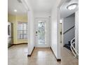 Bright entryway with tile floors, and access to the living room and stairs at 6435 Thicket Trl, New Port Richey, FL 34653