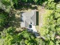 Aerial view of a modern home surrounded by lush greenery, highlighting its privacy and setting at 22426 Golden Retriever Ln, Brooksville, FL 34601