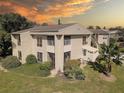 Condo with sunset view and surrounding landscape at 428 Windrush Bay Dr, Tarpon Springs, FL 34689