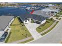 One-story home with a dark gray metal roof, paver driveway and waterfront view at 1810 4Th E St, Palmetto, FL 34221