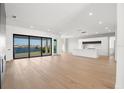 Open living space with hardwood floors, modern fireplace, and water views at 1810 4Th E St, Palmetto, FL 34221
