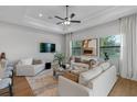 Spacious living room with hardwood floors, two sofas, and large windows at 4068 Southern Valley Loop, Brooksville, FL 34601