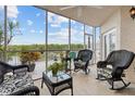 Relaxing screened porch with wicker furniture and water views at 6450 Shoreline Dr # 9105, St Petersburg, FL 33708
