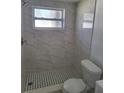 Updated bathroom with marble-tiled shower and modern vanity at 12800 Vassar Ct, Hudson, FL 34667