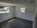 Bright bedroom with gray flooring and large windows at 12800 Vassar Ct, Hudson, FL 34667