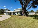 Two-story house with light gray exterior, driveway and landscaping at 1585 Delaware Ne Ave, St Petersburg, FL 33703