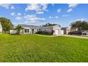 Newly renovated light taupe home with a detached garage and landscaped lawn at 5713 Ridgestone Dr, Tampa, FL 33625