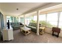 Relaxing sunroom with lots of windows, two sofas, and neutral decor at 12210 Buttonwood Row, Hudson, FL 34667