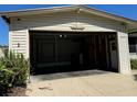 Empty attached garage with concrete floor and shelving at 34303 Lodge Dr, Wesley Chapel, FL 33543