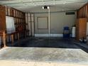 Attached garage with workbench and storage area at 34303 Lodge Dr, Wesley Chapel, FL 33543