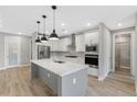 Modern kitchen with a large island, white cabinets, and quartz countertops at 4080 Southern Valley Loop, Brooksville, FL 34601