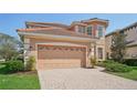 Two-car garage with a paver driveway at 18051 Java Isle Dr, Tampa, FL 33647