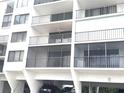 Multi-story building exterior showing balconies, car parking, and a well-maintained facade at 19111 Vista Bay Dr # 308, Indian Shores, FL 33785