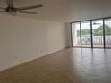 Bright living room featuring neutral walls, tile flooring, and sliding glass doors to a balcony at 19111 Vista Bay Dr # 308, Indian Shores, FL 33785