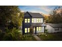 Stylish two-story house featuring modern design with dark siding and well-kept landscaping in a lush setting at 476 43Rd N Ave, St Petersburg, FL 33703