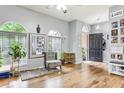 Living room with hardwood floors, gray sectional sofa, and access to backyard at 30552 Latourette Dr, Wesley Chapel, FL 33545