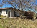 Ranch-style home with a large yard and mature trees at 620 Dalton Blvd, Port Charlotte, FL 33952