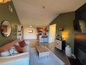 Bright living room featuring a cozy sofa and a view into the kitchen at 10263 Gandy N Blvd # 2114, St Petersburg, FL 33702