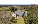 Aerial view of a house with a large green yard at 8831 Janmar Rd, Dade City, FL 33525