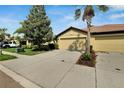 House exterior featuring a two-car garage and a neatly landscaped front yard at 5648 Sunset Falls Dr, Apollo Beach, FL 33572