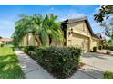 Two-story house with a two-car garage, lush landscaping, and a charming walkway at 5648 Sunset Falls Dr, Apollo Beach, FL 33572