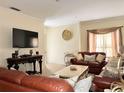 Bright and airy living room with comfortable brown leather sofas at 16511 Enclave Village Dr # 107, Tampa, FL 33647