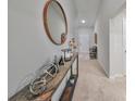 Bright hallway showcasing a stylish console table and mirror at 13114 Shumard Way, Riverview, FL 33579