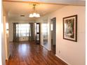 Inviting living room showcasing wood floors, chandelier, and natural light at 4254 96Th N Ter # Two, Pinellas Park, FL 33782