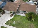 An aerial view of a charming home with a well-maintained lawn and inviting front porch seating area at 4608 Apple Ridge Ln, Tampa, FL 33624